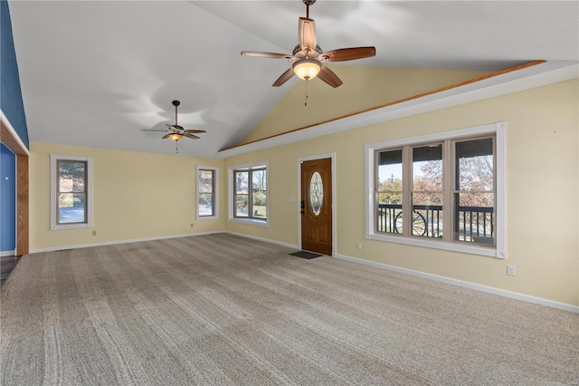 unfurnished living room with plenty of natural light, light colored carpet, and lofted ceiling