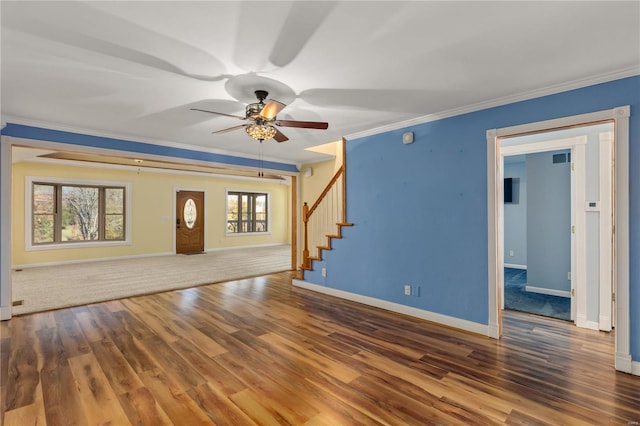 unfurnished living room featuring crown molding, ceiling fan, and dark wood-type flooring