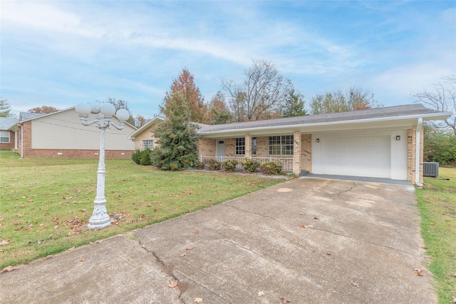 single story home with a garage, a front yard, and covered porch