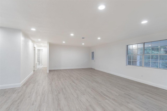 spare room featuring light hardwood / wood-style floors