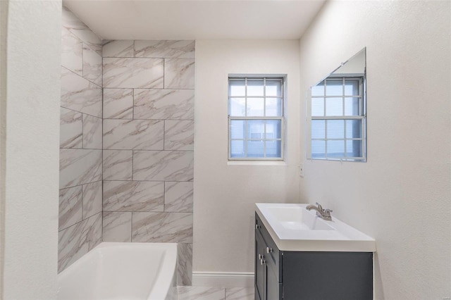 bathroom with vanity and a washtub