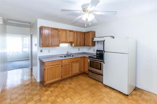 kitchen featuring sink, stainless steel electric range, light parquet flooring, and white refrigerator