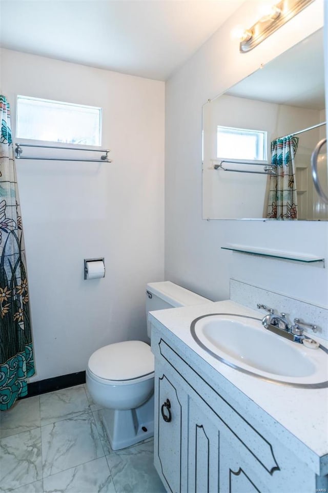 bathroom featuring vanity, toilet, and curtained shower