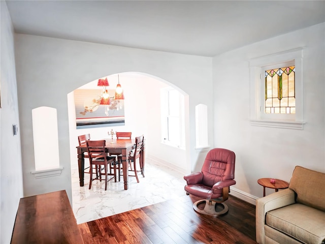 dining room featuring hardwood / wood-style floors and an inviting chandelier