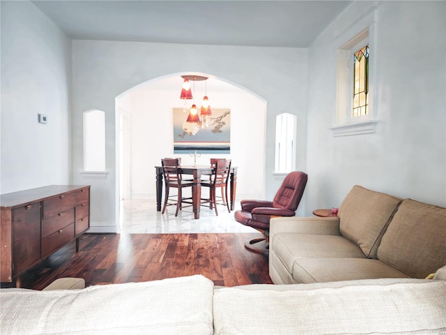 living room with a notable chandelier and dark hardwood / wood-style floors