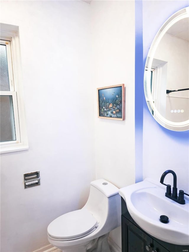 bathroom featuring toilet and vanity