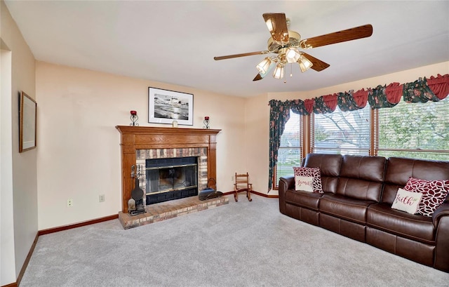 carpeted living room with ceiling fan and a fireplace