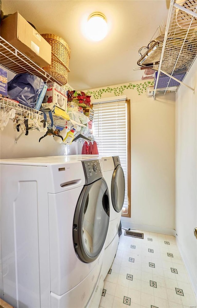 laundry room with separate washer and dryer