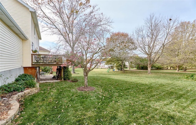 view of yard featuring a playground and a deck