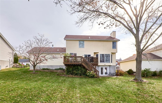 back of house with a deck, a yard, and french doors