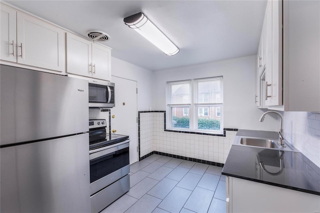 kitchen featuring white cabinets, sink, and appliances with stainless steel finishes