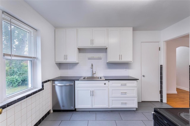 kitchen featuring stainless steel appliances, tile patterned floors, white cabinets, and sink