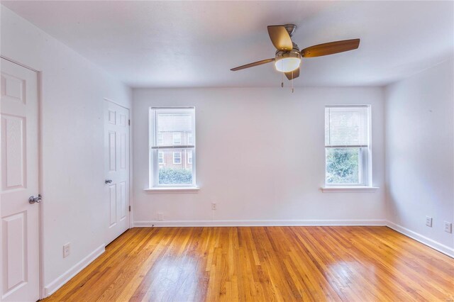 spare room featuring ceiling fan and light hardwood / wood-style flooring