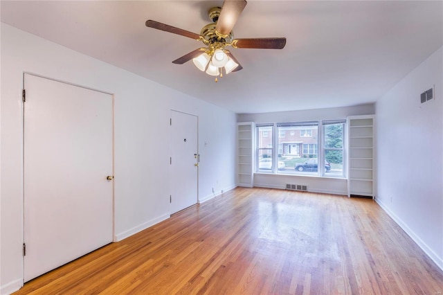 unfurnished room with ceiling fan and light wood-type flooring