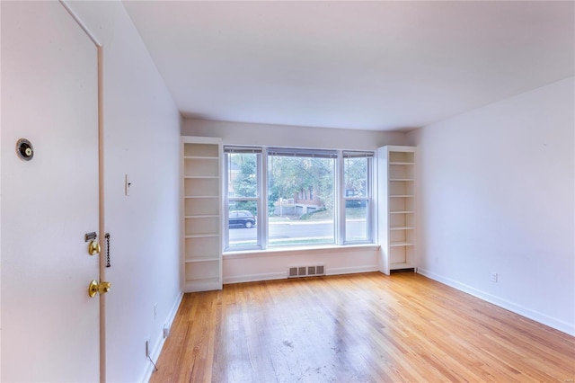 unfurnished room featuring light hardwood / wood-style floors