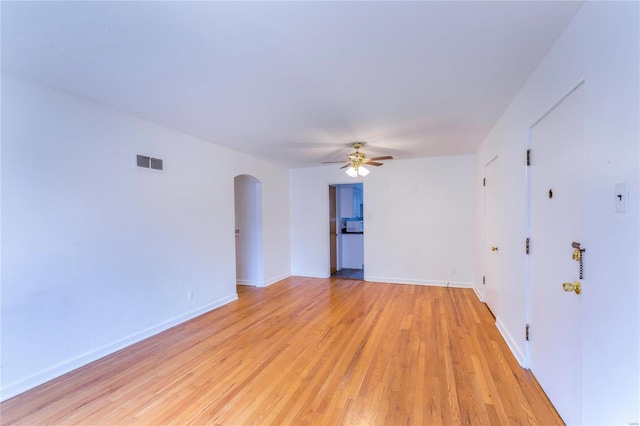 spare room featuring light hardwood / wood-style floors and ceiling fan