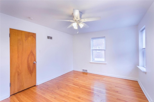 empty room with light wood-type flooring and ceiling fan