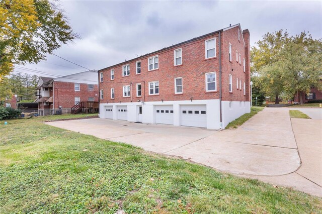 view of side of property with a garage and a yard