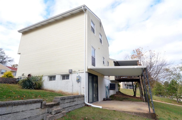 view of home's exterior featuring a carport and a yard