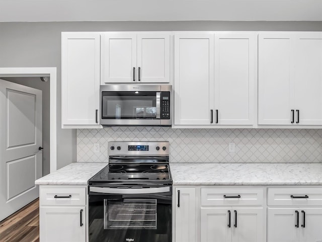 kitchen with white cabinetry, light stone countertops, and appliances with stainless steel finishes