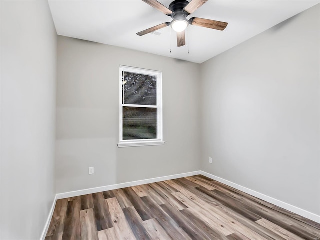 spare room with ceiling fan and wood-type flooring