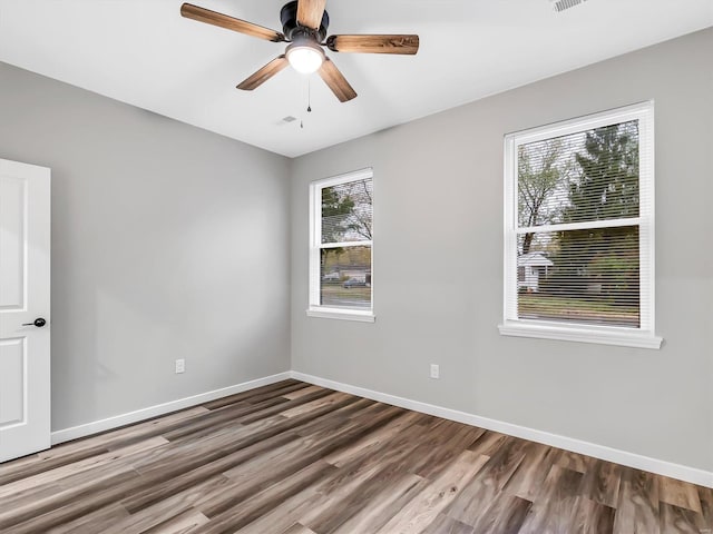 unfurnished room with ceiling fan and wood-type flooring