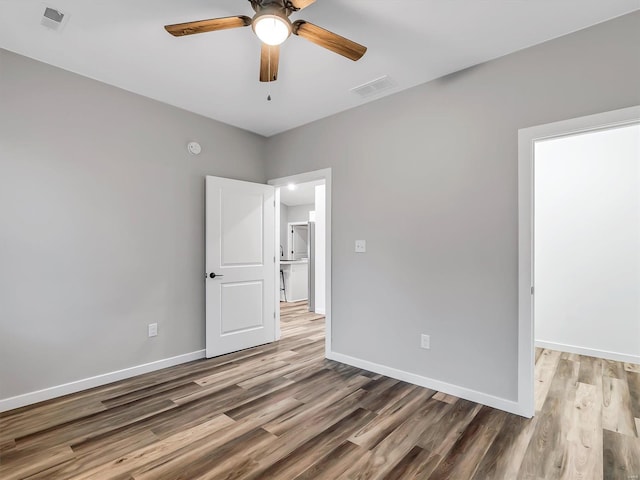 unfurnished room with ceiling fan and hardwood / wood-style flooring