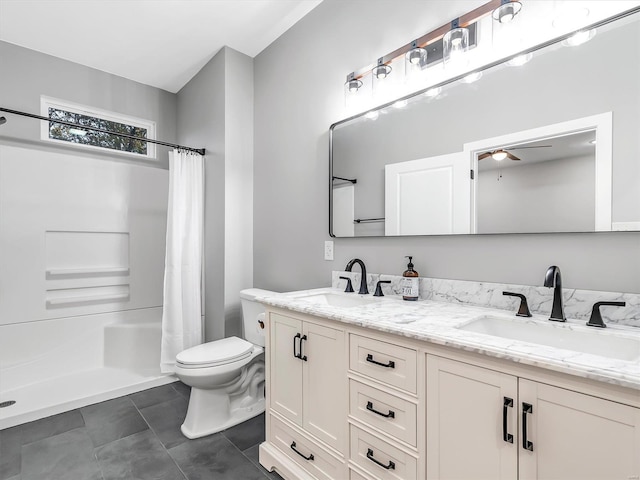 bathroom with tile patterned floors, a shower with curtain, vanity, ceiling fan, and toilet