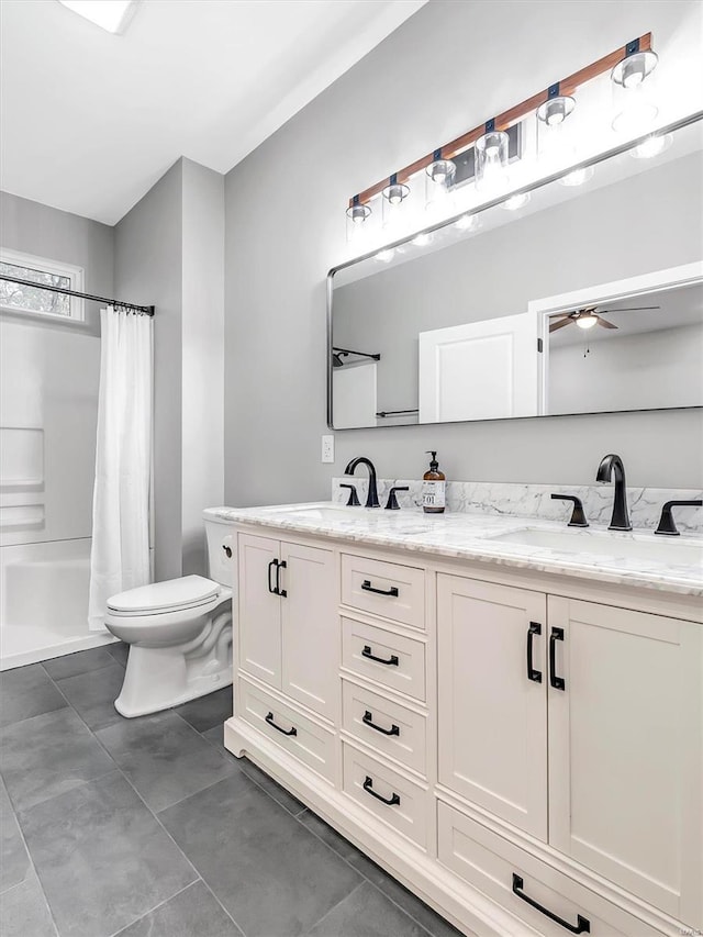 bathroom with tile patterned floors, ceiling fan, vanity, and toilet