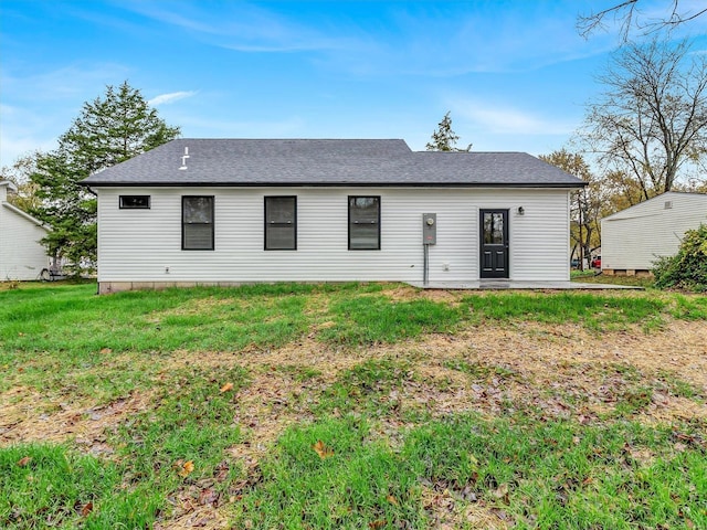 back of house with a lawn