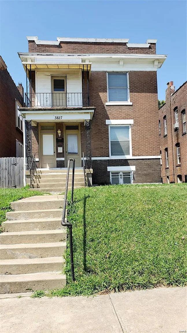 view of front of property featuring covered porch and a balcony