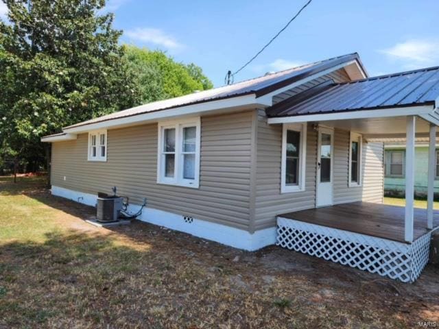 back of property featuring central AC and a deck