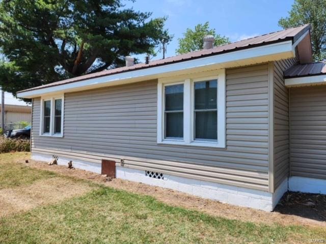 view of property exterior with a yard