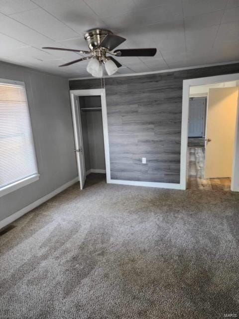 unfurnished bedroom featuring a closet, carpet flooring, and ceiling fan