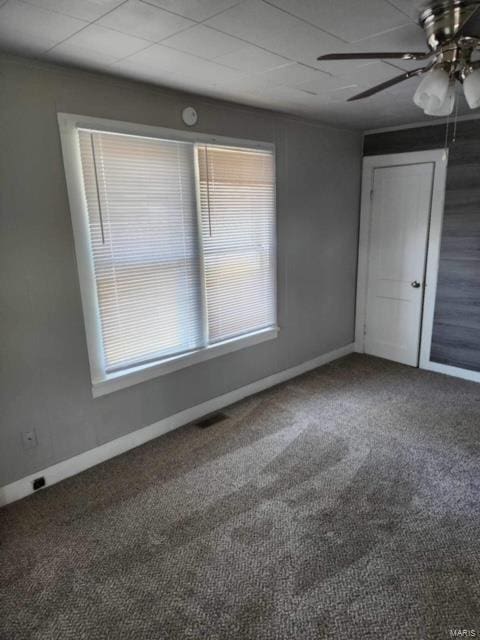 unfurnished room featuring ceiling fan and carpet floors