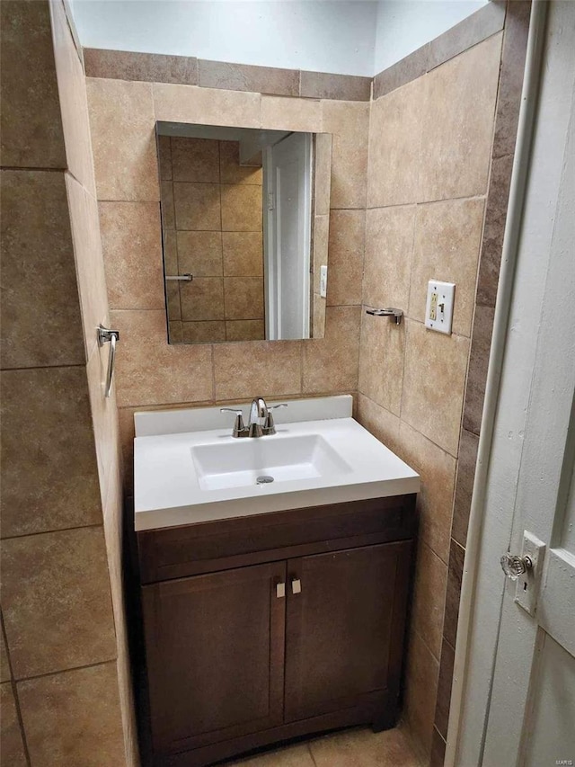 bathroom with tile walls and vanity