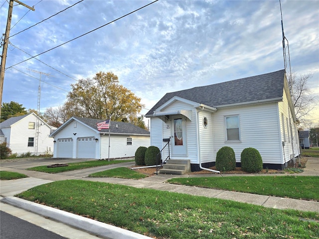 bungalow-style home featuring a garage and a front lawn