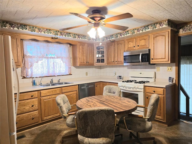 kitchen with backsplash, ceiling fan, sink, and appliances with stainless steel finishes