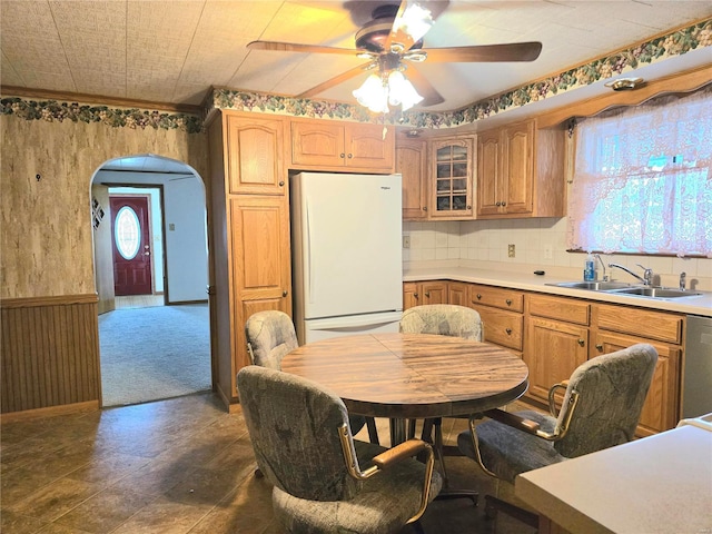 kitchen with stainless steel dishwasher, ceiling fan, dark wood-type flooring, sink, and white refrigerator