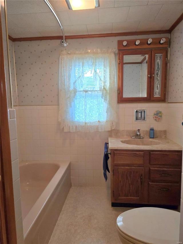 full bathroom featuring crown molding, toilet, shower / tub combination, vanity, and tile walls