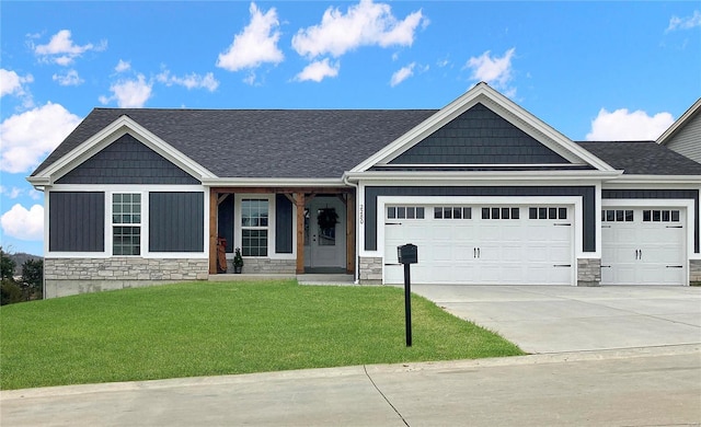 craftsman house featuring a garage, a porch, and a front yard