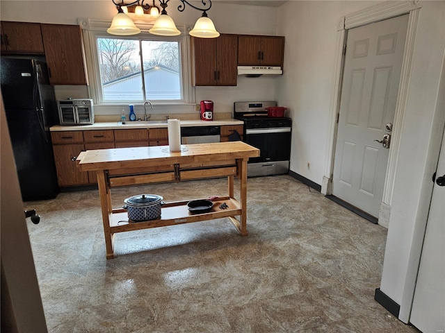 kitchen with dark brown cabinetry, sink, stainless steel range oven, pendant lighting, and black refrigerator