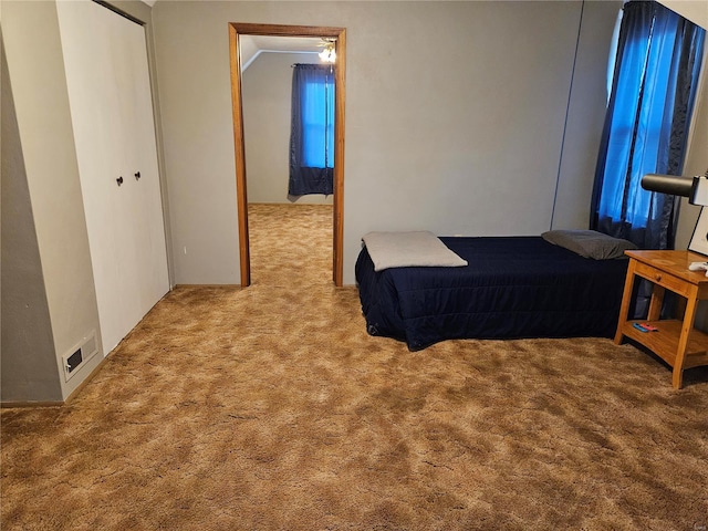 bedroom featuring crown molding, a closet, and carpet