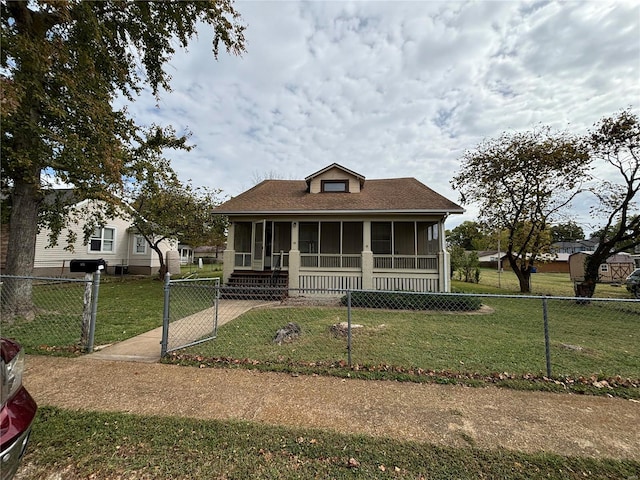 bungalow featuring a sunroom and a front lawn