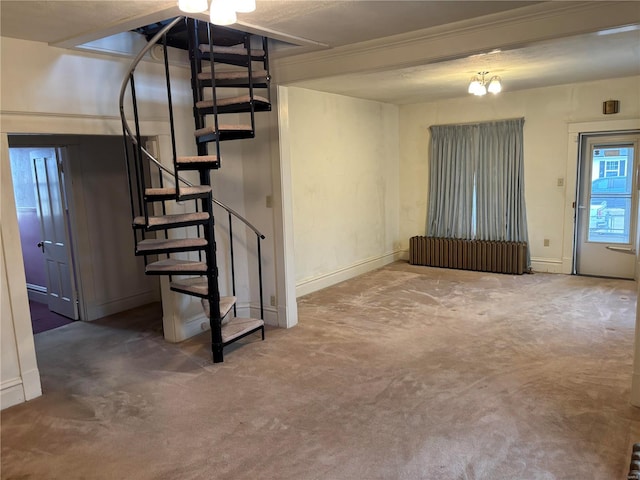 interior space with a notable chandelier, carpet floors, and radiator