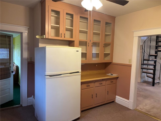 kitchen with ceiling fan, white refrigerator, and light carpet