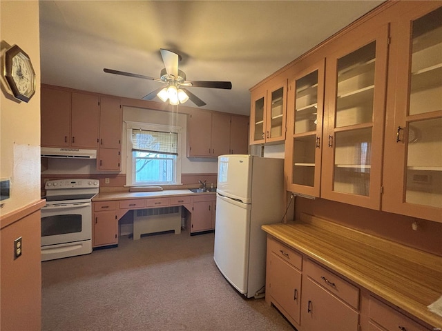 kitchen with light carpet, white appliances, ceiling fan, and sink