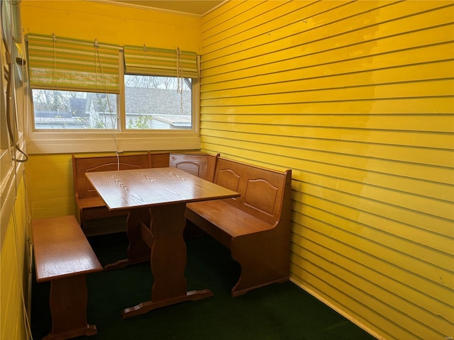 dining room with wooden walls