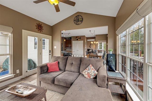 living room with ceiling fan with notable chandelier and lofted ceiling