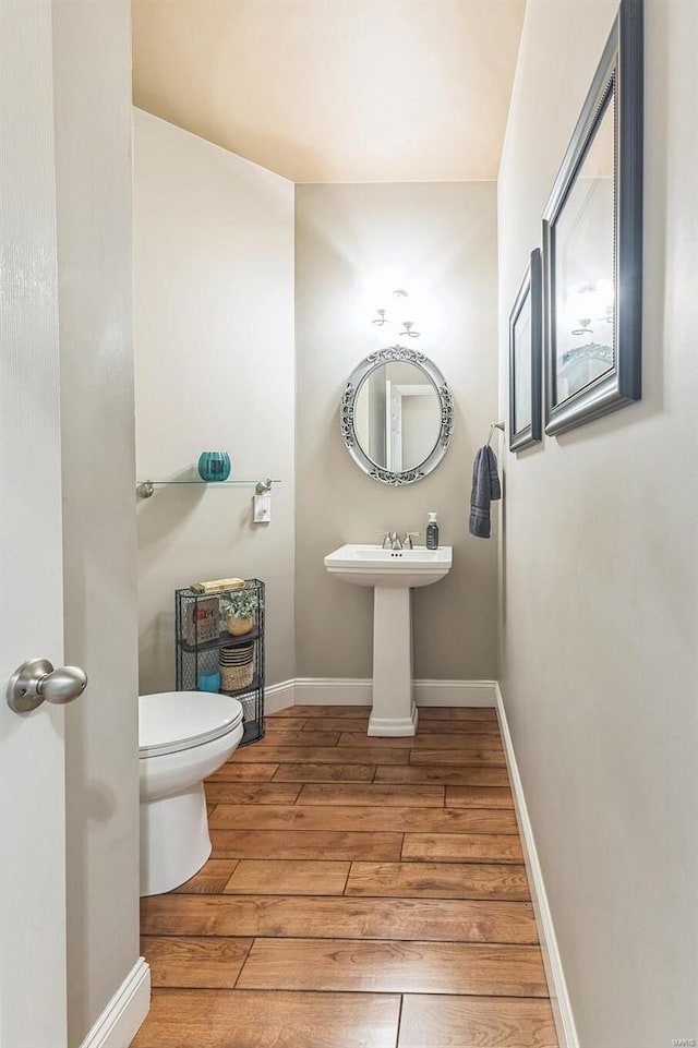 bathroom featuring hardwood / wood-style floors and toilet